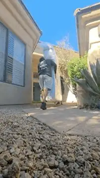 Gorilla Movers crew member walking a dolly up a desert path on a Phoenix, Arizona move
