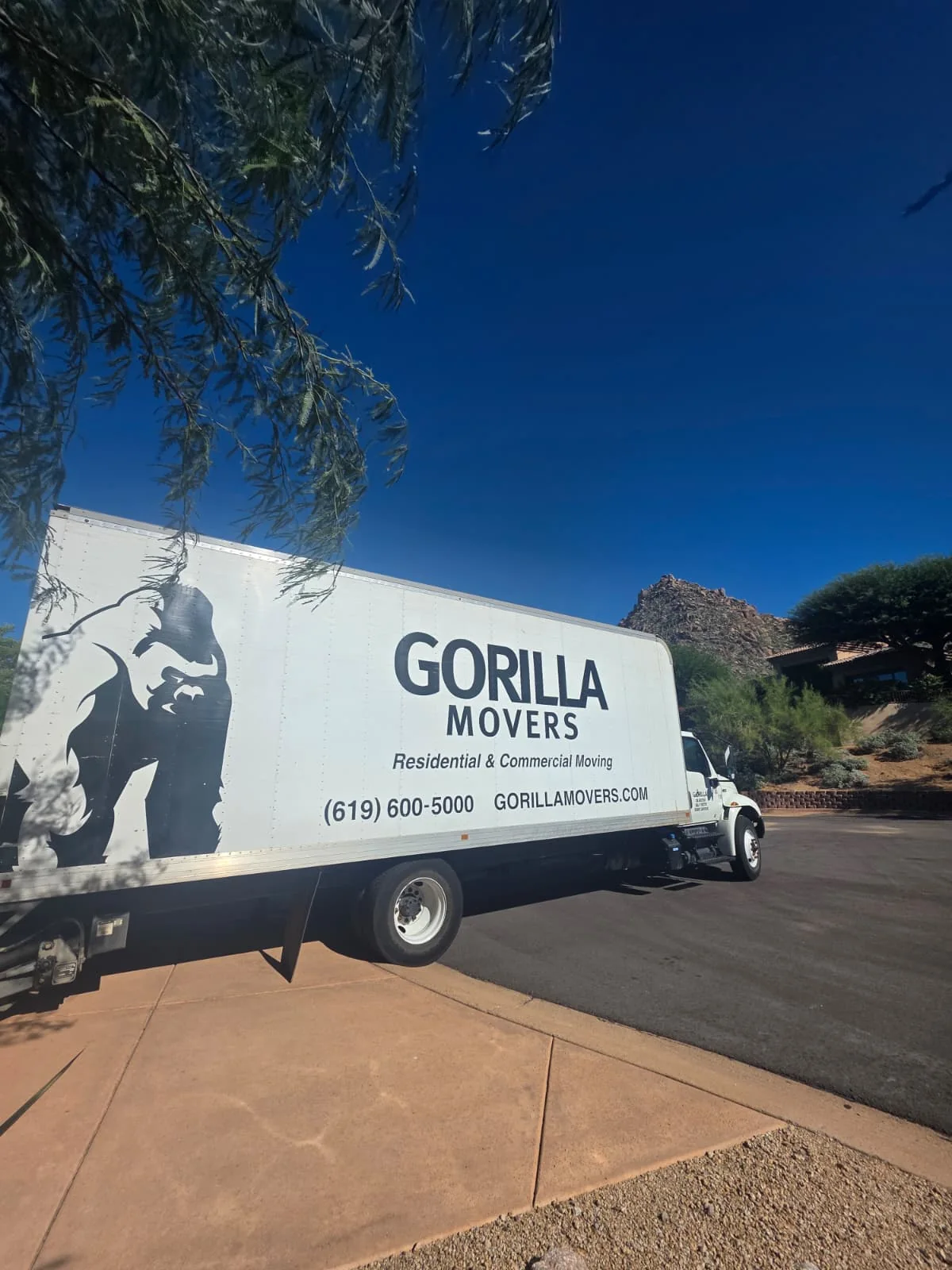Gorilla Movers truck on an Arizona driveway with a red rock formation behind it