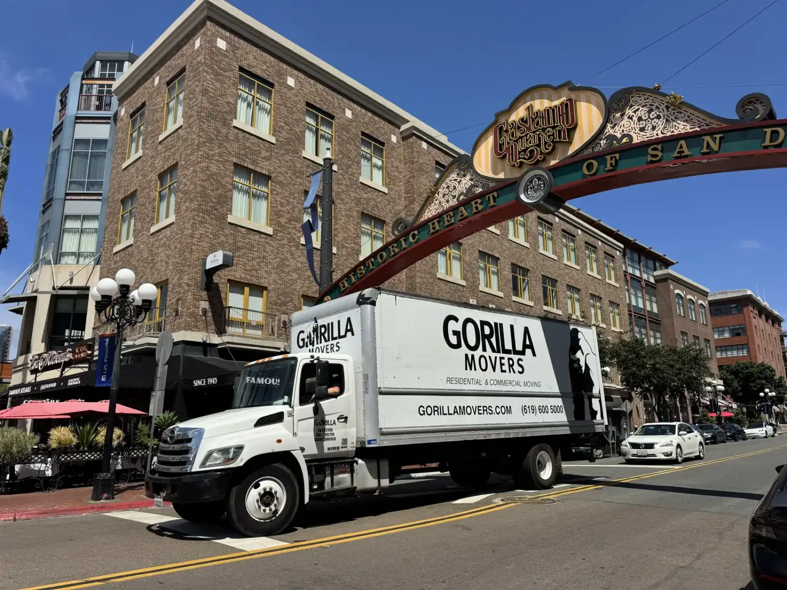 Gorilla Movers box truck parked under the Gaslamp Quarter sign in downtown San Diego