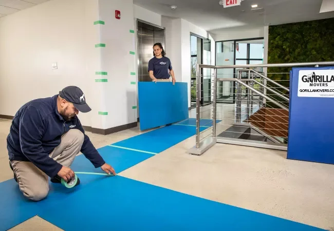 Gorilla Movers crew laying floor protection on a San Diego job